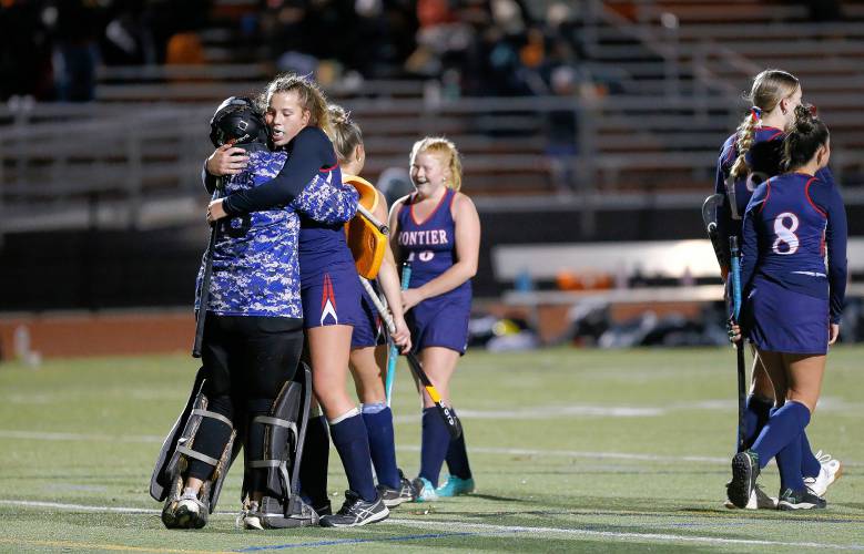 Frontier’s Harper Modestow hugs goalkeeper Kyra Richards after the MIAA Div. 4 field hockey state semifinal game against Uxbridge on Tuesday at Agawam High School.