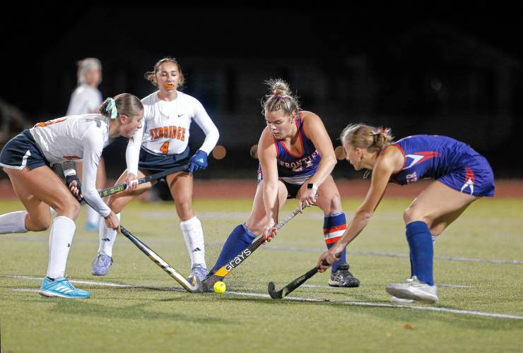 Frontier’s Claire Kirkendall (21) and Macy DeMaio (1) defend against Uxbridge’s Kendall Gilmore (3) and Addie Blood (4) in the first half of the MIAA Div. 4 field hockey state semifinal Tuesday at Agawam High School.