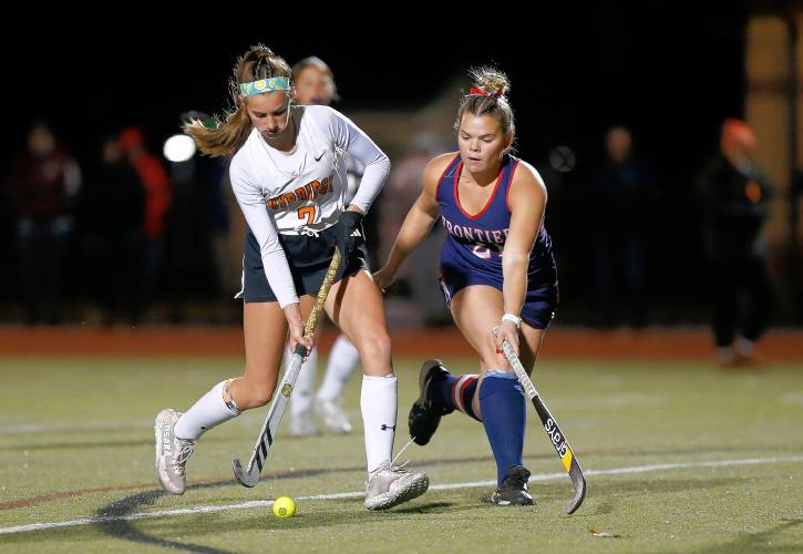 Frontier’s Claire Kirkendall (21) defends against Uxbridge’s Aubrey Bouchard (7) in the third quarter of the MIAA Div. 4 field hockey state semifinal Tuesday at Agawam High School.