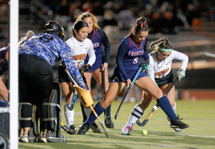 Frontier’s Amelia Bouchard (8) defends in front of the net against Uxbridge’s Elyse Bouchard (12) and Julianna Casucci (1) in the fourth quarter of the MIAA Div. 4 field hockey state semifinal Tuesday at Agawam High School.