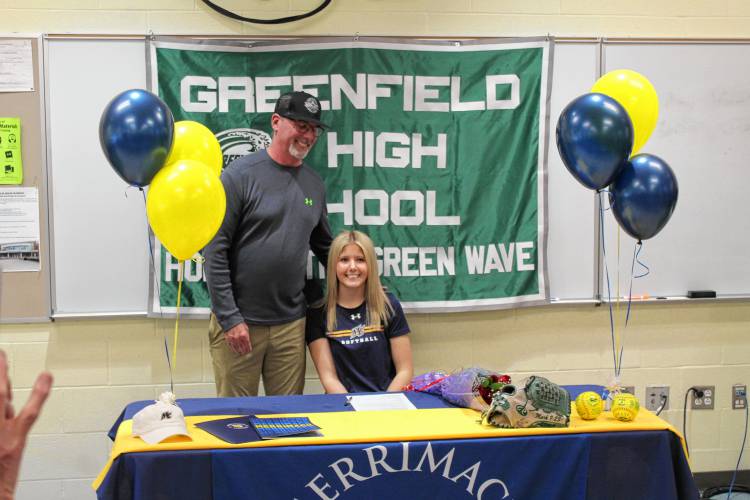 Greenfield’s MacKenzie Paulin with former Greenfield softball coach John Hickey after signing her National Letter of Intent on Wednesday to play softball at Merrimack College next fall.