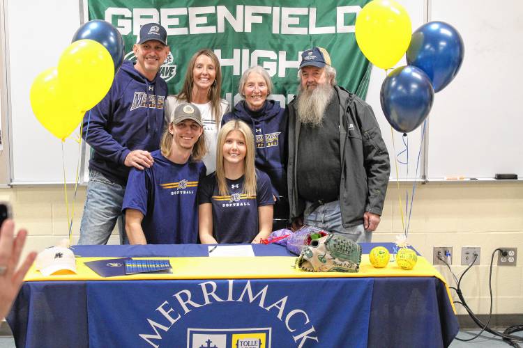 Greenfield’s MacKenzie Paulin surrounded by her family  after signing her National Letter of Intent on Wednesday to play softball at Merrimack College next fall.