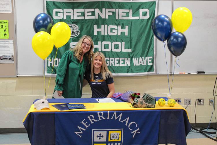 Greenfield’s MacKenzie Paulin with Greenfield superintendent Karin Patenaude  after signing her National Letter of Intent on Wednesday to play softball at Merrimack College next fall.