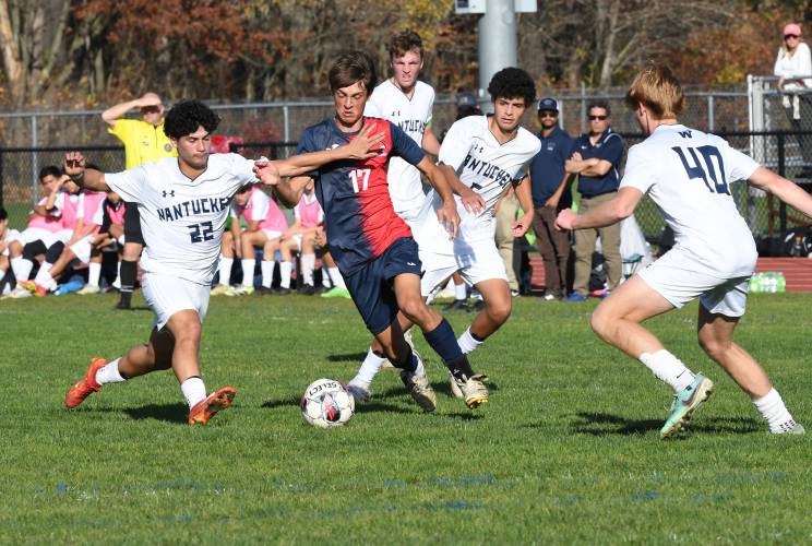 Frontier’s Eric Larsson dribbles through a group of Natucket defenders in South Deerfield during the Redhawks’ MIAA Div. 4 Round of 32 contest last week.