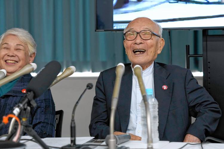 Terumi Tanaka, right, co-chairperson of Nihon Hidankyo, and assistant Secretary General Toshiko Hamanaka smile during a press conference in Tokyo on Oct. 12, a day after Nihon Hidankyo won the Nobel Peace Prize.