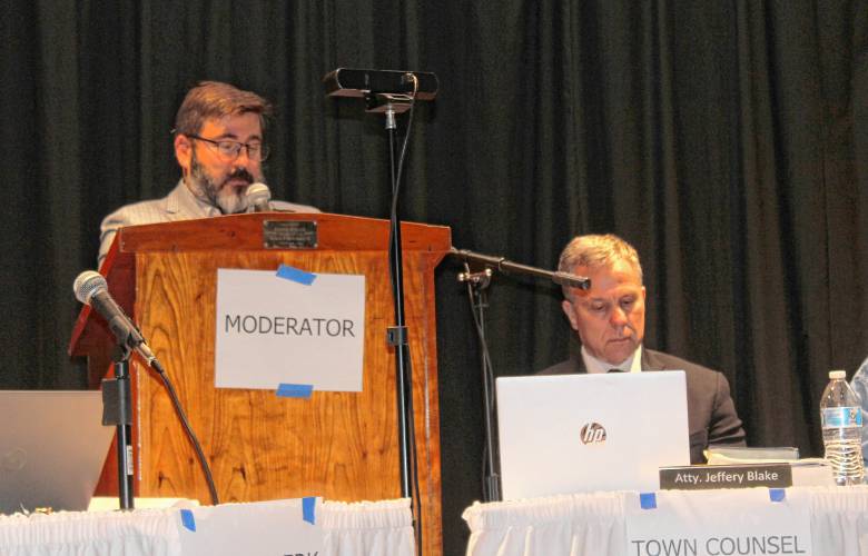 Moderator Nathan L’Etoile and town counsel Jeffrey Blake on the stage of Pioneer Valley Regional School’s auditorium during Wednesday’s Special Town Meeting in Northfield.