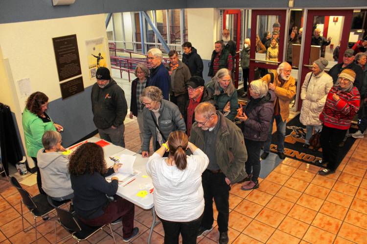 Northfield voters file into Pioneer Valley Regional School for a Special Town Meeting on Wednesday. Roughly 250 voters attended.