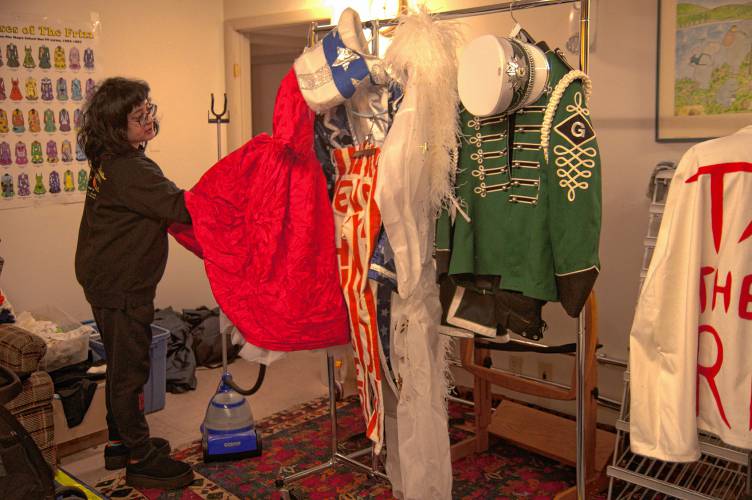 Buckingham Rabbits Vintage owner Alex McGuigan with some of Christopher “Monte” Belmonte’s outfits used during the annual march to support the Food Bank of Western Massachusetts.