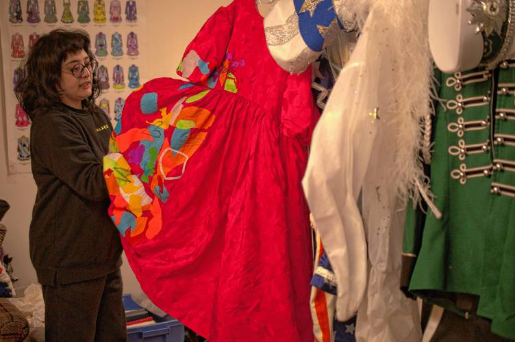 Buckingham Rabbits Vintage owner Alex McGuigan with some of Christopher “Monte” Belmonte’s outfits used during the annual march to support the Food Bank of Western Massachusetts.