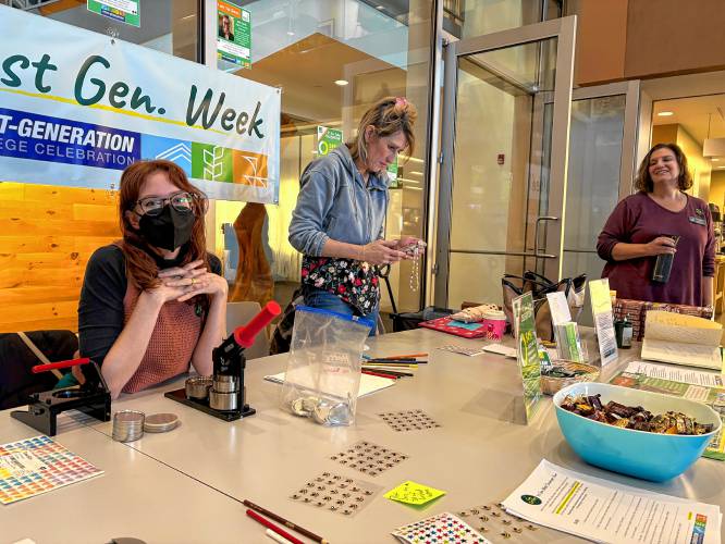 First-generation college student Chelsea Rossier sits at a Greenfield Community College tabling event for “First Generation Week.”