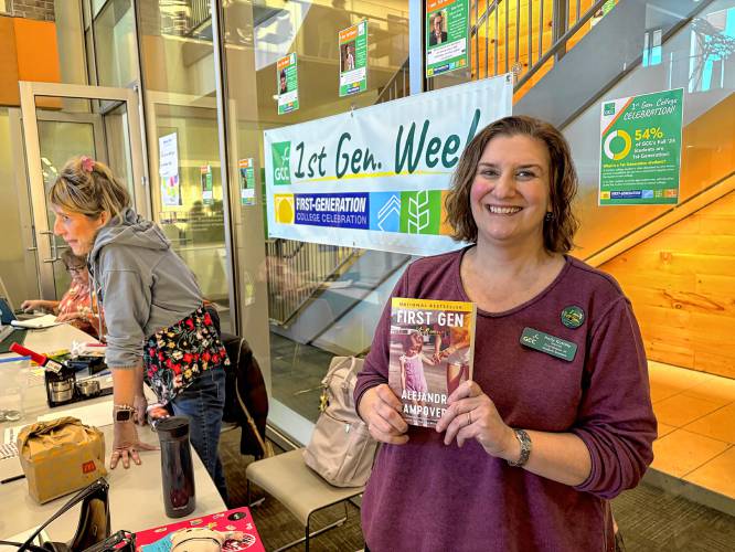 Greenfield Community College Coordinator of Student Success Holly Kosinski holds Alejandra Campoverdi’s memoir “First Gen” at the college’s “First Generation Week.”