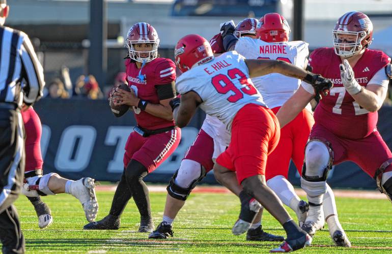 UMass freshman quarterback A.J. Hairston surveys the Liberty defense during the Minutemen’s 35-34 overtime loss on Saturday at McGuirk Alumni Stadium in Amherst.