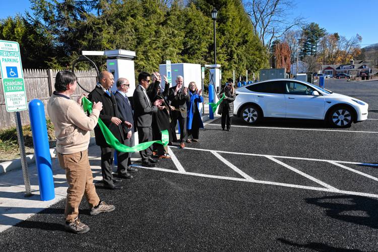 Federal, state and local officials cut a ribbon in front of the industry-leading electric vehicle charging station at the new Leary Lot in the center of South Deerfield on Friday.