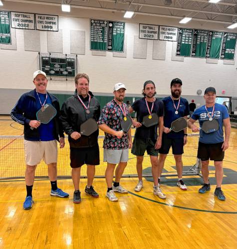 Jonathan MacLeod and Nathan Barber-Smith (center) after winning the Competitive Division championship in the Greater Greenfield Pickleball Tournament at Greenfield High School Sunday. 