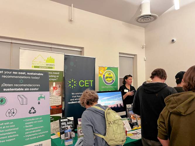 Center for EcoTechnology (CET) Customer Relationships Lead Khrysti Berry (back right) speaks with attendees during the Energy Fair hosted by Greening Greenfield at the Jon Zon Community Center Monday night.