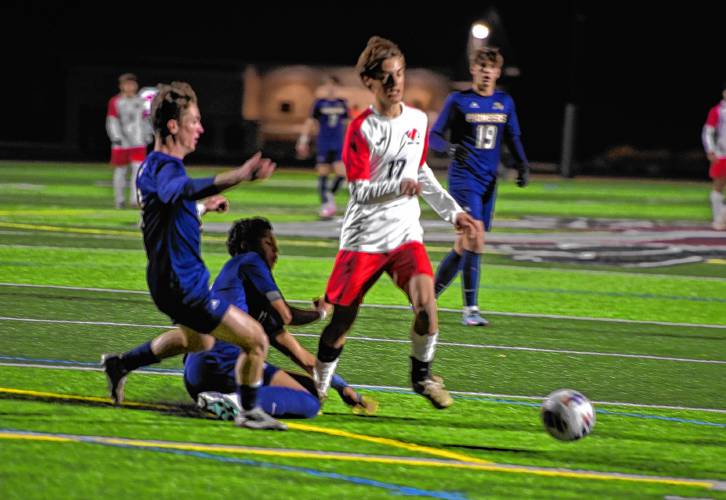 Frontier’s Eric Larsson dribbles through a pair of Lynnfield defenders during an MIAA Div. 4 semifinal contest at Ayer Shirley High School Tuesday.