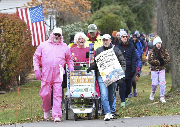 Greenfield Cooperative Bank is sponsoring a rest stop at its Sunderland branch on Tuesday, Nov. 26, for participants in the 15th annual March for the Food Bank with Monte Belmonte, pictured making their way through South Deerfield in 2023.