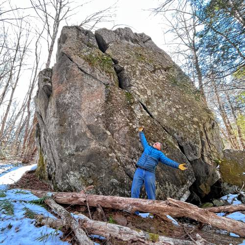 Ashfield Trails Treasurer Phil Pless with a glacial boulder along the new Hilltown Boulders Trail.