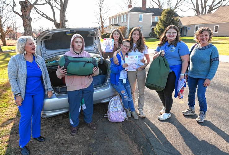 Donation drive organizer Heather Perna, left, Four Rivers Charter Public School students and history teacher Joanna Morse, right. On Wednesday, the Four Rivers students packed up sleeping bags to donate to Perna’s drive, which supports the homeless.