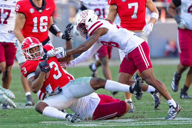 Georgia running back Nate Frazier (3) is stopped by UMass cornerback Jerrod Cameron (28) during the Minutemen’s 59-21 loss to the Bulldogs on Saturday afternoon at Sanford Stadium in Athens, Ga.