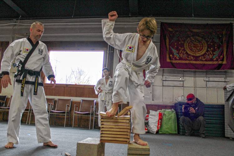 Callum Joyce, 12, attempts to break 10 boards, with instructor Peter Harrington standing by. This was Callum’s last break of the day, bringing him to a total of 250 boards broken during the 22nd annual “Break-athon” at the Greenfield Tae Kwon Do Center.