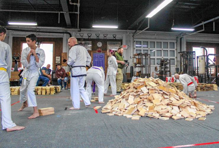 The 22nd annual “Break-athon” to raise money for the Greenfield Recorder’s Warm the Children charity was held at the Greenfield Tae Kwon Do Center on Saturday. The pile of broken boards in the center of the room grew in size as the day progressed. Each broken board represents a pledged dollar amount to the charity.