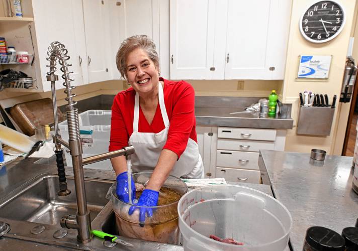 Kirsten Levitt, executive director and chef at Stone Soup Café in Greenfield, is brining turkeys in advance of the Thanksgiving meal. 