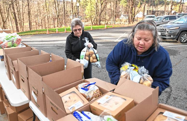 Diane Rogers and Barbara Viencek put together Thanksgiving meals on Friday afternoon at the Bernardston Senior Center. 