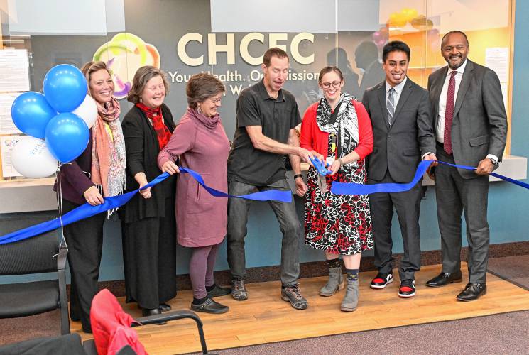 Cutting the ribbon at the new Community Health Center of Franklin County location in Turners Falls on Monday are, from left, Rep. Natalie Blais, Sen. Jo Comerford, Phoebe Walker of the Franklin Regional Council of Governments, health center board of directors President Garth Shaneyfelt, health center CEO Allison van der Velden, Koby Gardner-Levine of U.S. Rep. James McGovern’s office, and Massachusetts League of Community Health Centers President and CEO Michael Curry.