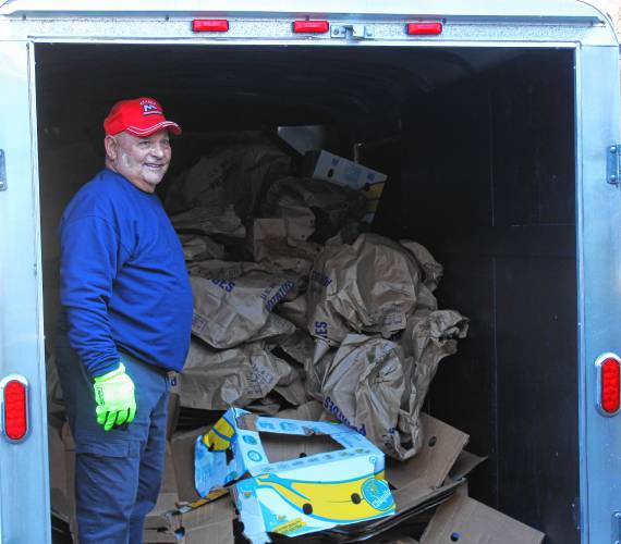 Jeff Suprenant, a retired Greenfield Police officer, with a trailer of cardboard and paper to be recycled following the assembling of 150 Thanksgiving food boxes at the Schuetzen Verein in Gill on Monday morning.