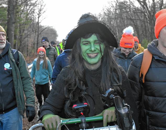 Christopher “Monte” Belmonte, dressed as Elphaba Thropp, the green-faced witch from “Wicked,” during the March for the Food Bank as it makes its way up Greenfield Road (Routes 5 and 10) in Deerfield on Tuesday.