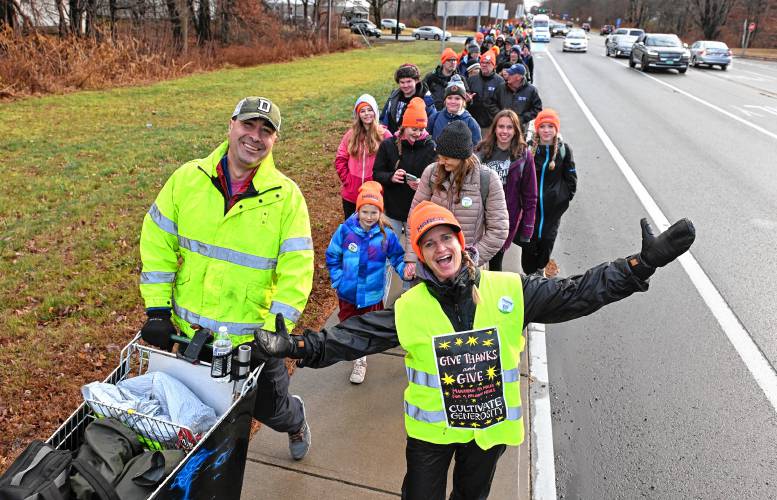 Ben Clark of Clarkdale Fruit Farms, left, pushes his own shopping cart during the March for the Food Bank with Monte Belmonte as it makes its way up Greenfield Road (Routes 5 and 10) in Deerfield on Tuesday. He is accompanied by Emily Lichter.