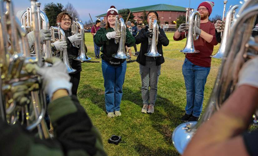 Emma Taylor, Anabelle Daly and Sam Lee warm up with the section of euphonium players with the UMass band while practicing for the Macy’s Thanksgiving Day Parade.