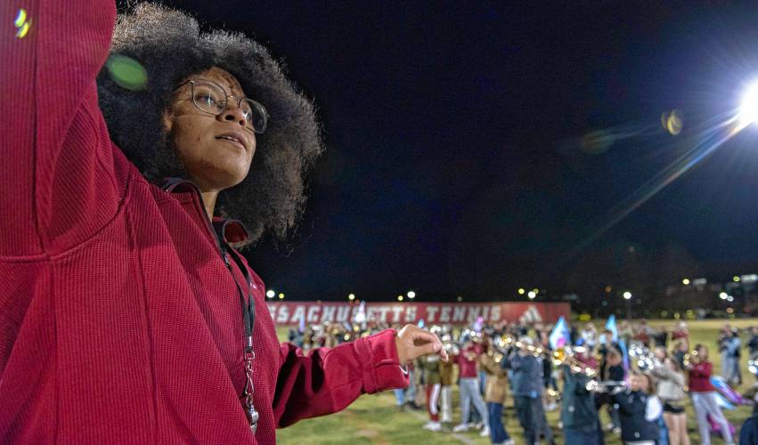 Qeanu Smith, a drum major with the UMass marching band, stands on a ladder while practicing with the band for the Macy’s Thanksgiving Day Parade.