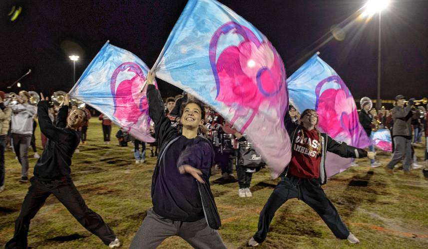 Olivia Fuoti, left, Brianda DeLeon, middle, and Audrey Brecher, right, members of the UMass marching band, practice with about 400 other band members for the Macy’s Thanksgiving Day Parade.