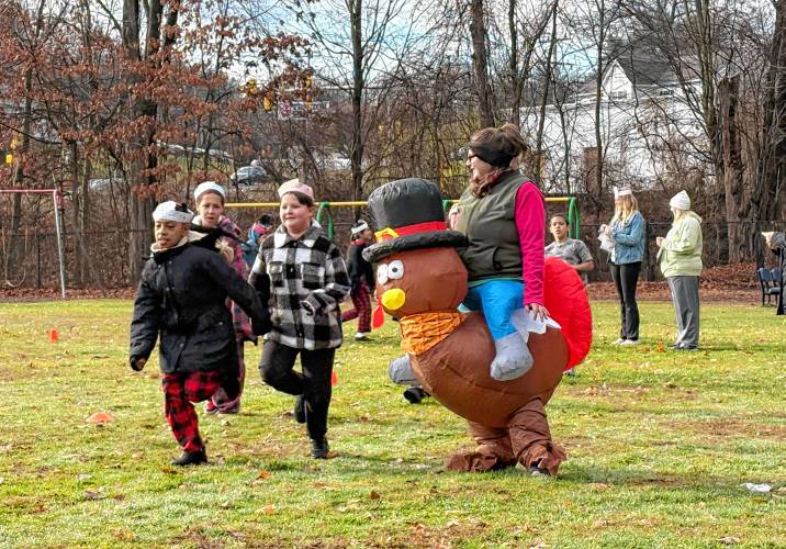 Samantha Whitman, building monitor at Newton School in Greenfield, wears a turkey costume during the school’s turkey trot on Wednesday morning.