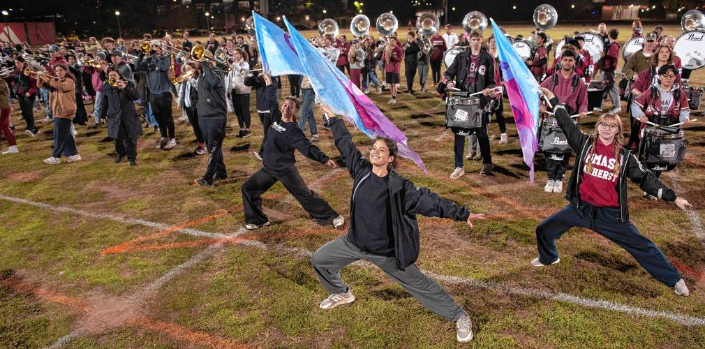 Olivia Fuoti, left, Brianda DeLeon and Audrey Brecher, members of the UMass marching band, practice with about 400 other band members for the Macy’s Thanksgiving Day Parade.