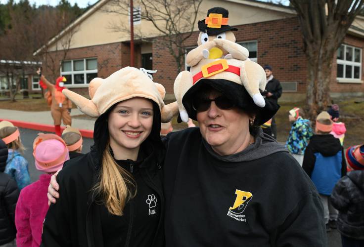 Former student Lucy Burnap and kindergarten teacher Renee Keir don turkey hats at Bernardston Elementary School’s annual turkey trot on Wednesday morning.