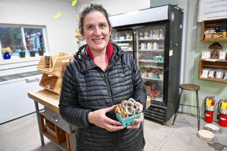 Julia Coffey with mushrooms in the farm store at Mycoterra Farm in Deerfield.