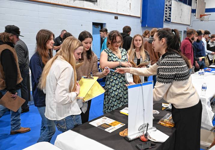 Nicole Lussier, right, of Framingham State University, talks with juniors and seniors at Franklin County Technical School during a career and college expo on Tuesday.