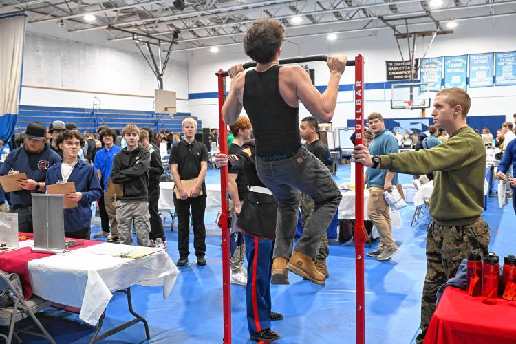 A student participates in a pull-up challenge set up by the U.S. Marines at Franklin County Technical School during a career and college expo on Tuesday.