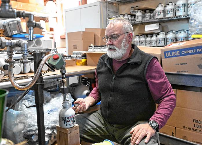 Howard Boyden fills pints of maple syrup at Boyden Brothers Maple in Conway.