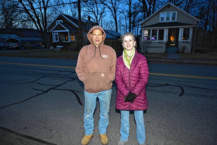 Greenfield residents Michael Johnson and Karen Bergeron stand across from their home on Newton Street near where a cell tower has been proposed.