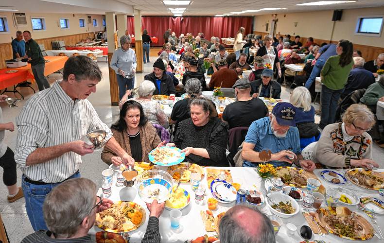 Volunteer Robert Willard of Athol helps serve more than 100 people gathered for the free community meal put on at Athol American Legion Post 102 on Thanksgiving.