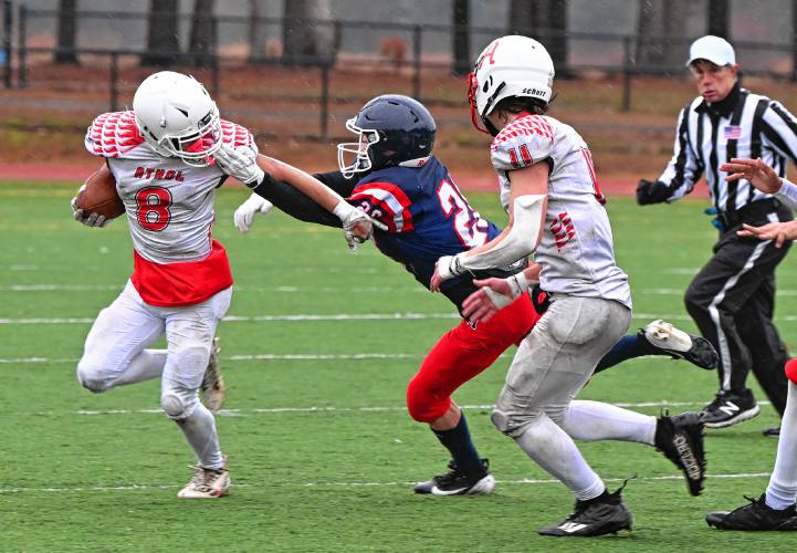 Athol’s Raydin Sousa picks up yards and a face mask penalty in the first quarter against Mahar in Orange on Thursday.