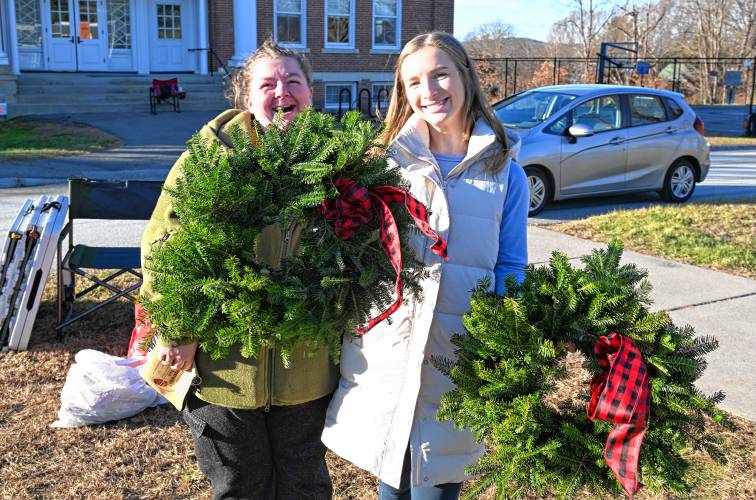 Megan Beaulieu of the Northfield Elementary School Parent-Teacher Organization (PTO), left,  sells some of the last wreaths to Deerfield resident Brittany Pickunka during a fundraiser on Wednesday.