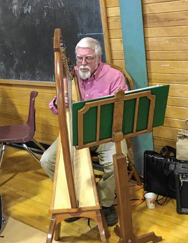 Clyde Perkins Jr. will play the harp in the Warwick Community School gymnasium during a holiday craft fair on Saturday, Nov. 30.