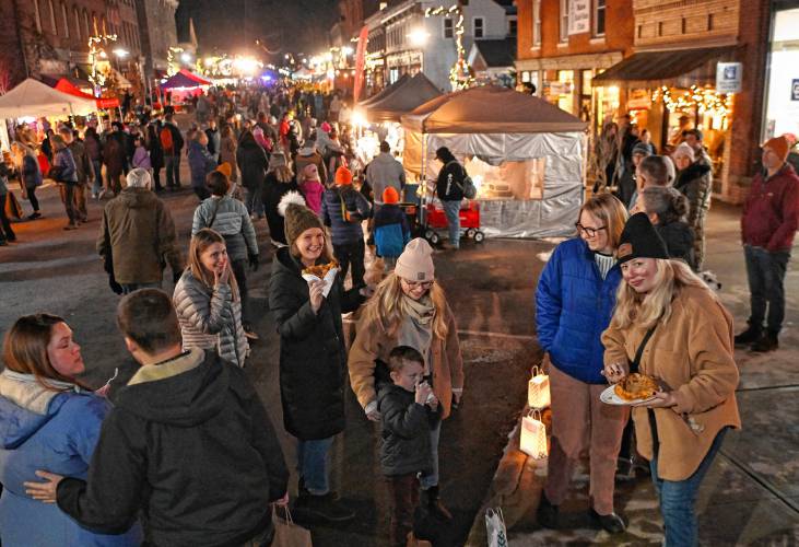 People enjoy fried dough and other treats at Moonlight Magic in Shelburne Falls on Friday night.