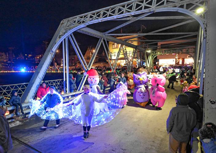 Characters parade across the Iron Bridge at Moonlight Magic in Shelburne Falls on Friday night.