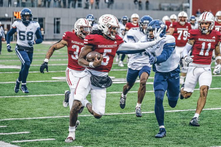 UMass freshman quarterback Ahmad Haston (5) runs deep into UConn territory during the second half of the Minutemen’s 47-42 loss to the Huskies in their season finale on Saturday afternoon at McGuirk Alumni Stadium in Amherst.